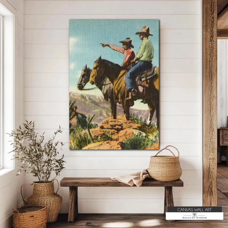 Vintage Western canvas wall art featuring two cowboys on horseback surveying the open frontier. The rugged landscape and earthy tones add rustic charm to any Western or Southwestern-inspired space.